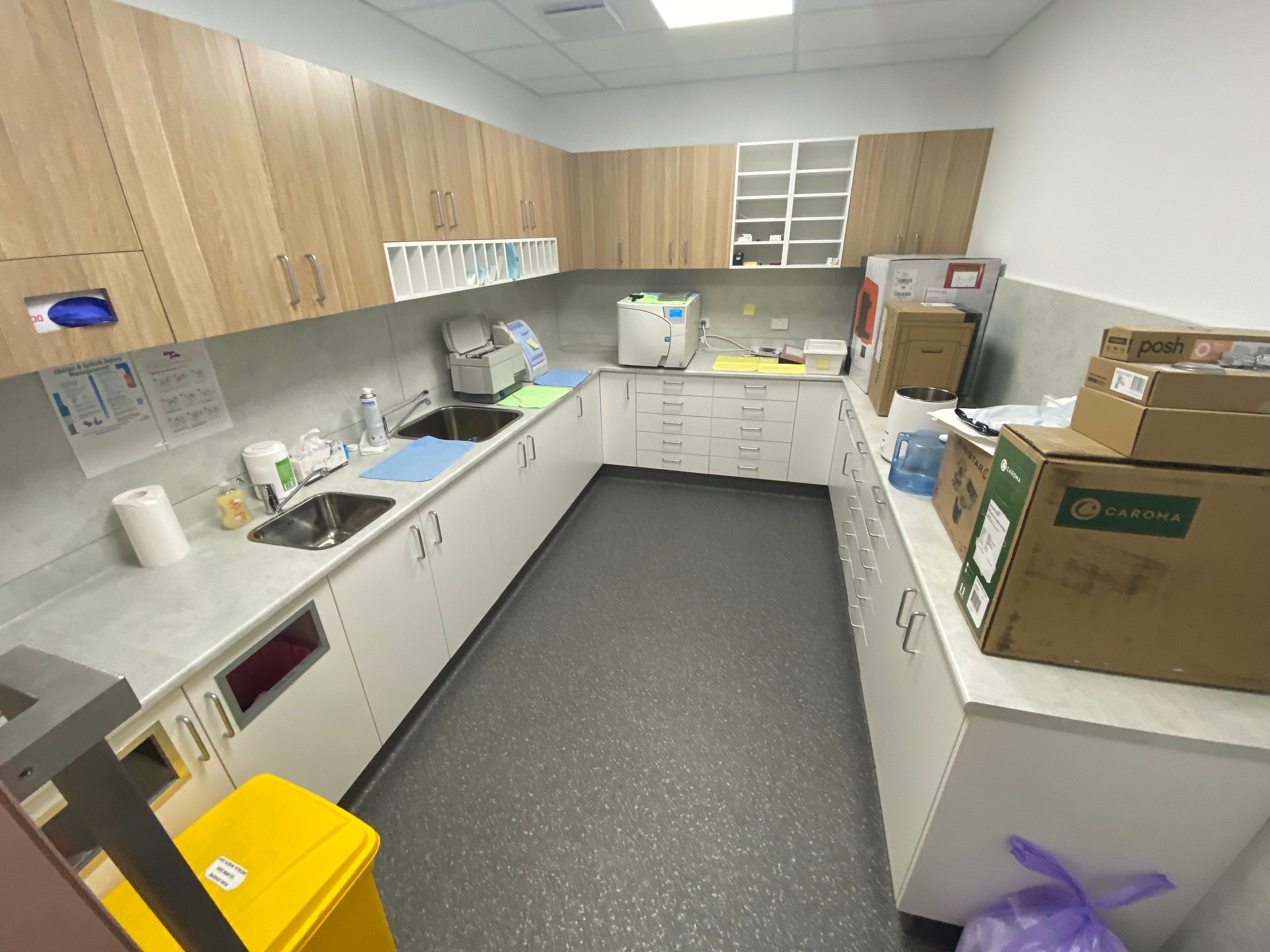 Dental treatment room — dark navy cabinetry and terrazzo floor